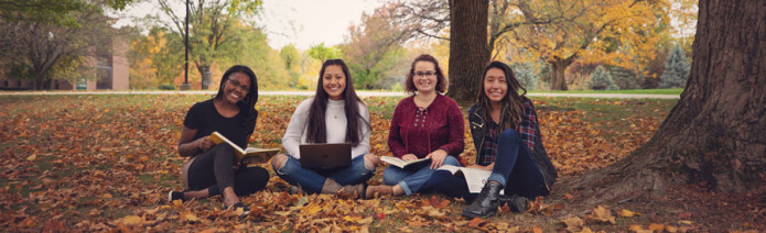 HU students studying under the trees on campus. 