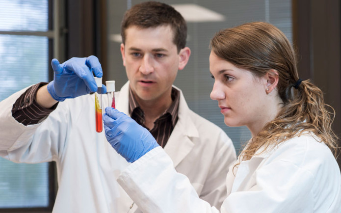 HU student and professor comparing their experiment. 