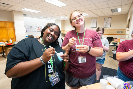 Two summer nursing camp students smile at the camera