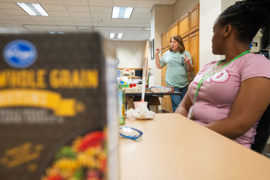 A nursing instructor teaching summer nursing camp students