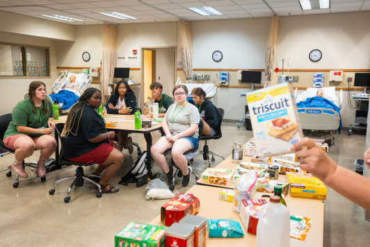 A group of summer nursing camp students learn about nutrition.