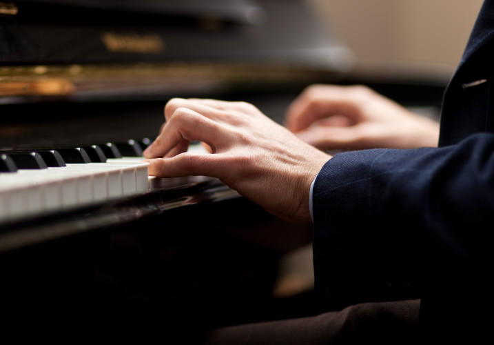 A closeup shot of hands playing piano.