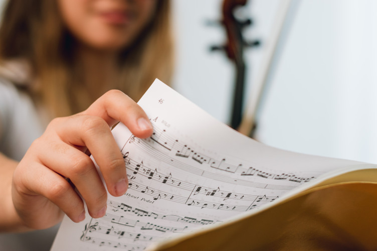 A closeup shot of a student interacting with sheet music.