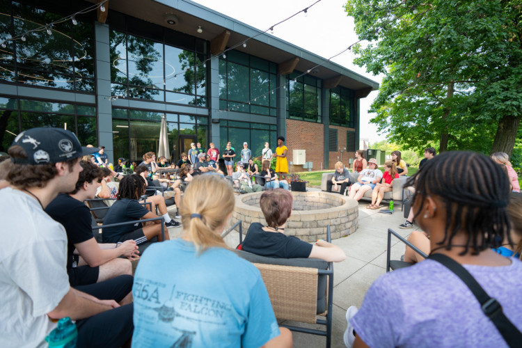 A large group of summer camp students gathering behind the Huntington University HUB