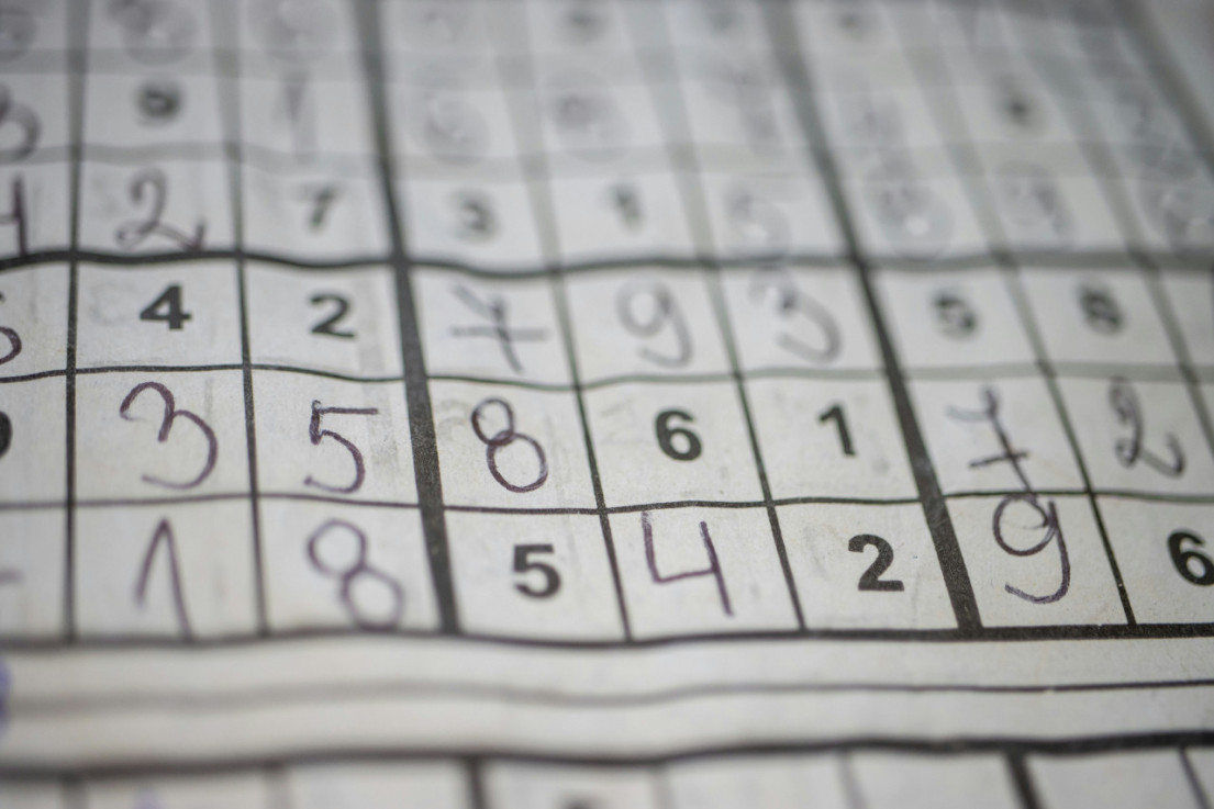 Completed Sudoku puzzle grid on paper. 