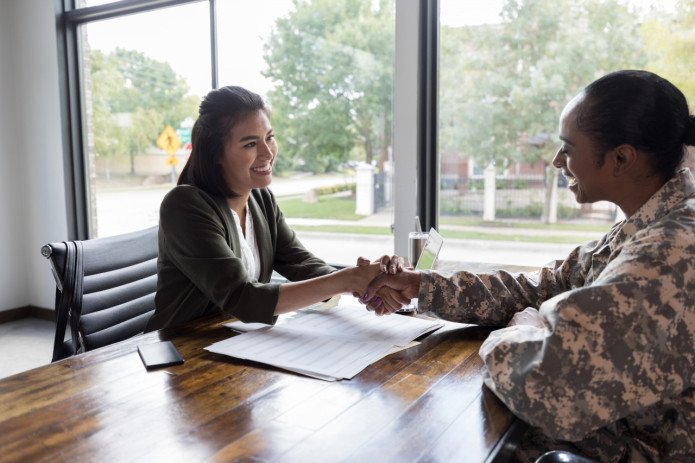 Two people in agreement, shaking hands.