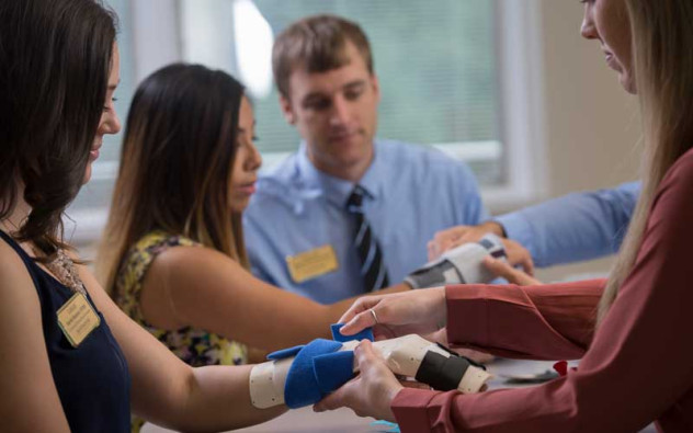 HU students practicing immobilizing a wrist.