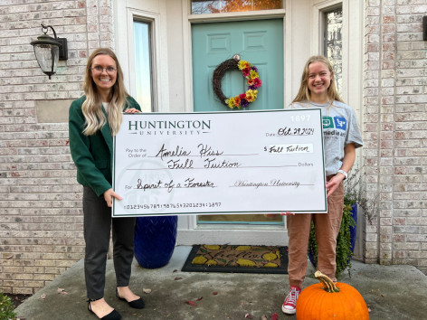 This photo shows two women holding an oversized check for the amount of "Full Tuition". This was recently taken in recognition to winning a scholarship competition.