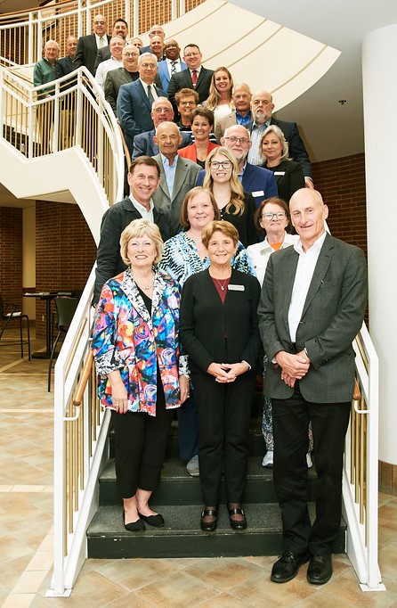 The 2024 Board of Trustees for Huntington University standing on the staircase of Dowden Science Hall.