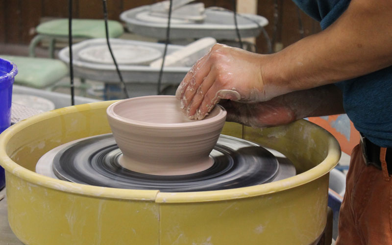 HU student doing pottery.