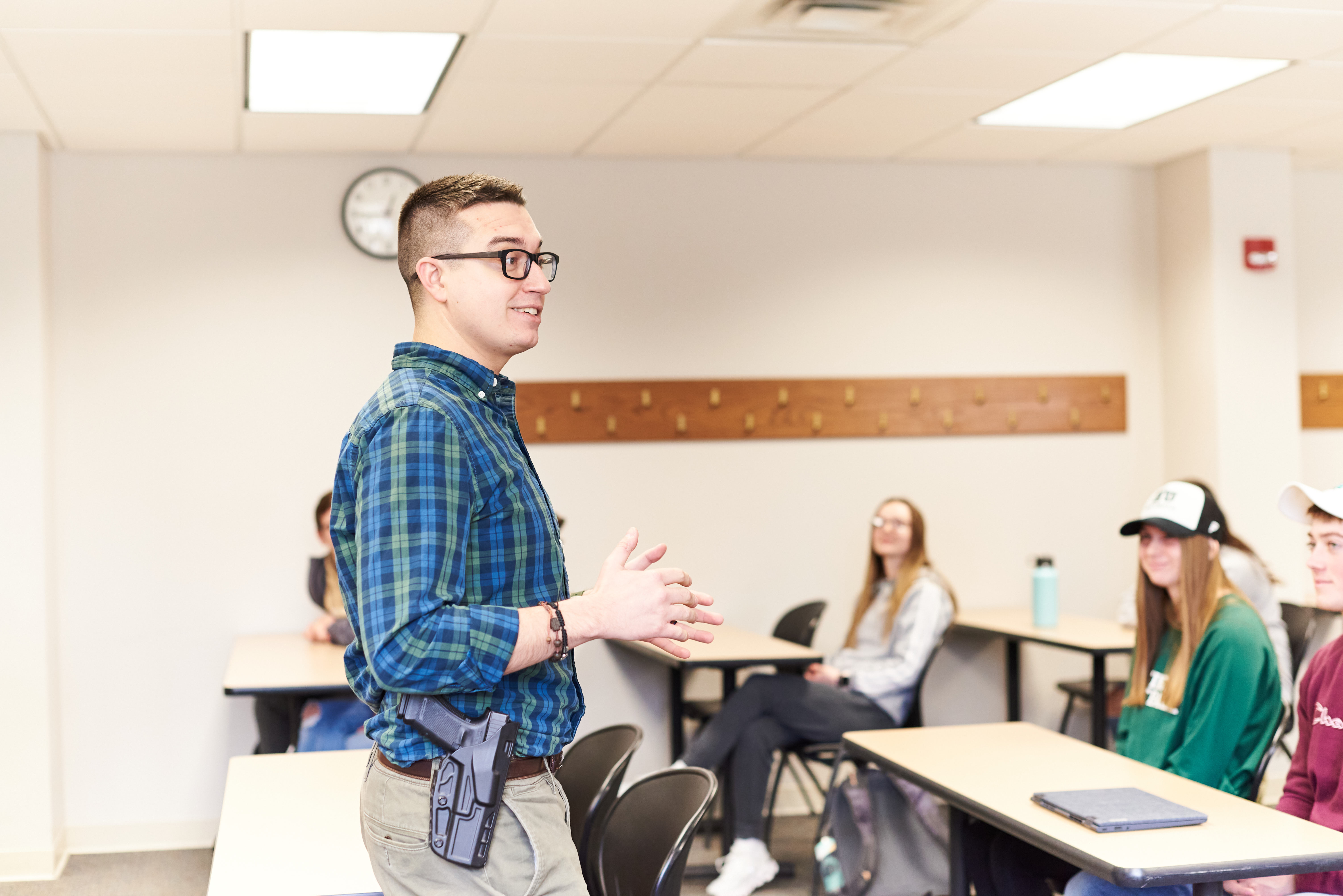 A law enforcement officer teaches Criminal Justice students in a classroom.