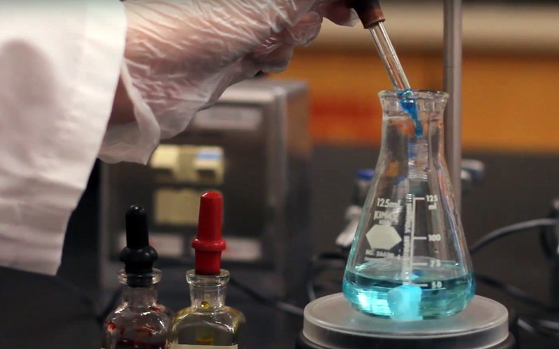 A closeup of someone doing a chemistry experiment.